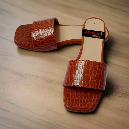 Brown crocodile-patterned sandals on a wooden surface with 'Metro Shoes' tag.