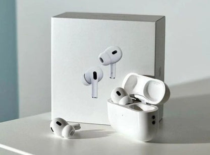 White wireless earbuds with charging case on a light gray surface