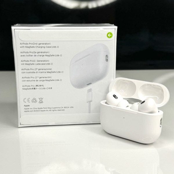 White wireless earbuds in a charging case with packaging on a white background